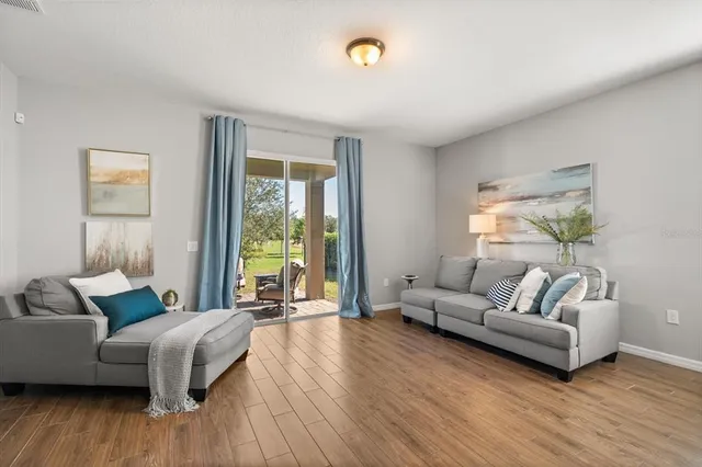 a living room with furniture and a large window