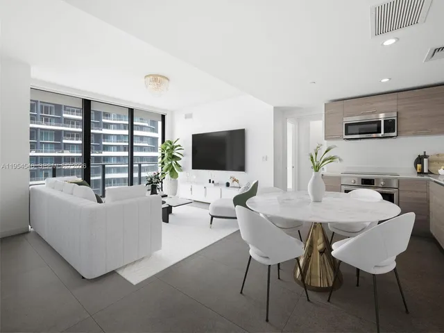a view of empty room with a kitchen