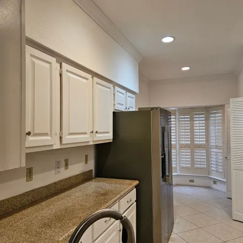 a kitchen with stainless steel appliances granite countertop a refrigerator and a stove top oven