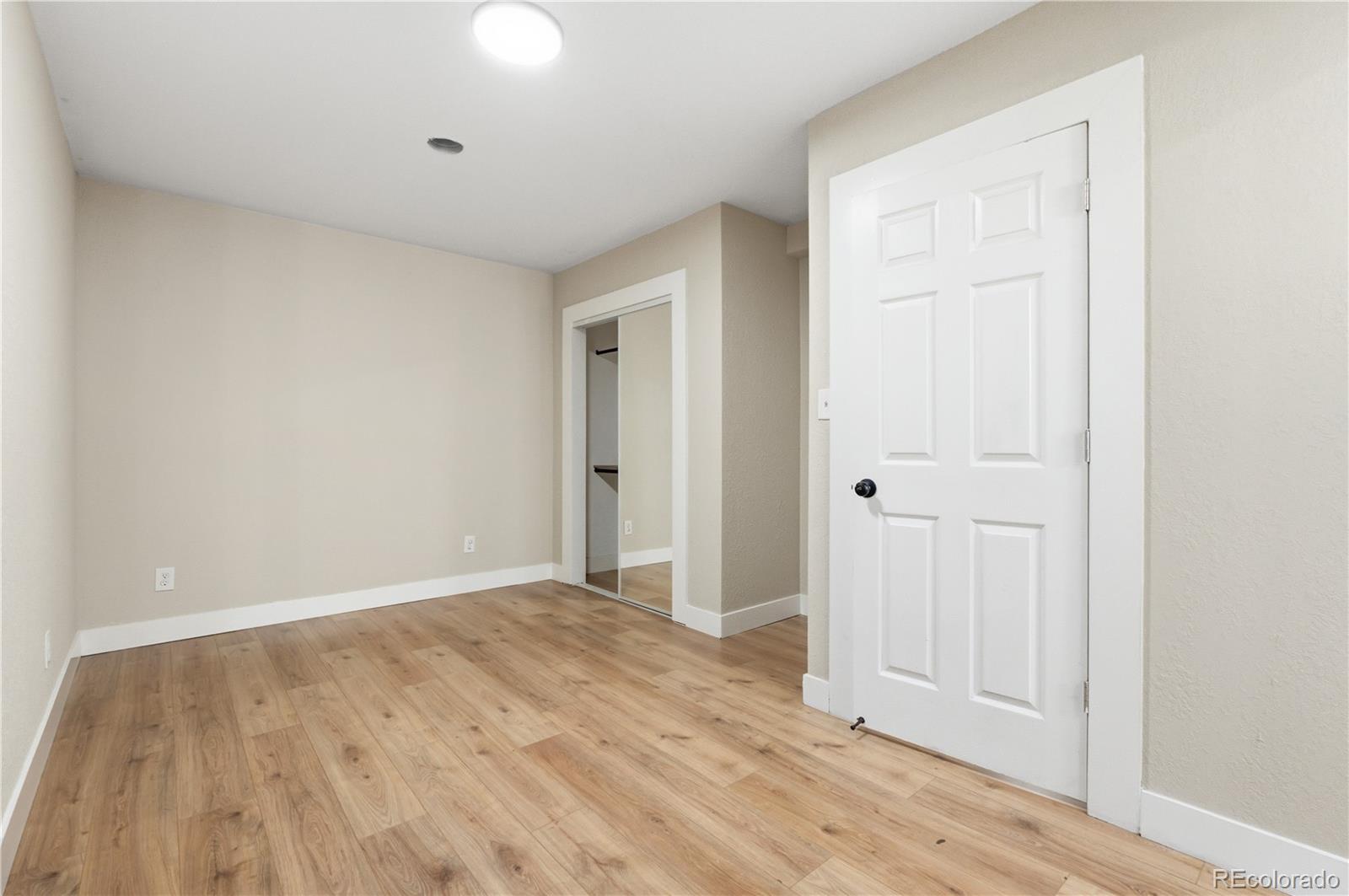 610 6th Street Bennett, CO 80102 - Photo 18 of 34 wooden floor in an empty room