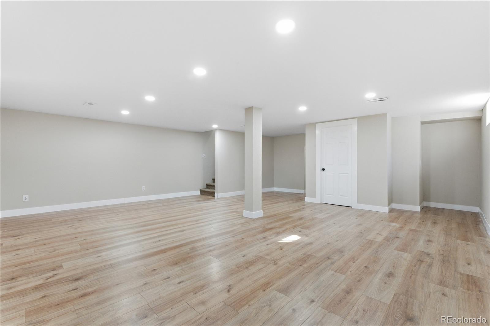 610 6th Street Bennett, CO 80102 - Photo 26 of 34 a view of an empty room with wooden floor