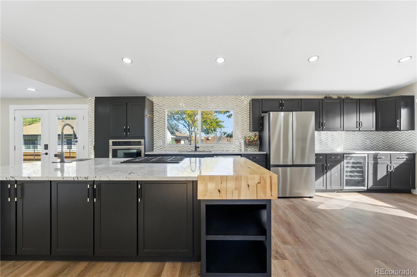610 6th Street Bennett, CO 80102 - Photo 27 of 34 a kitchen with refrigerator and cabinets