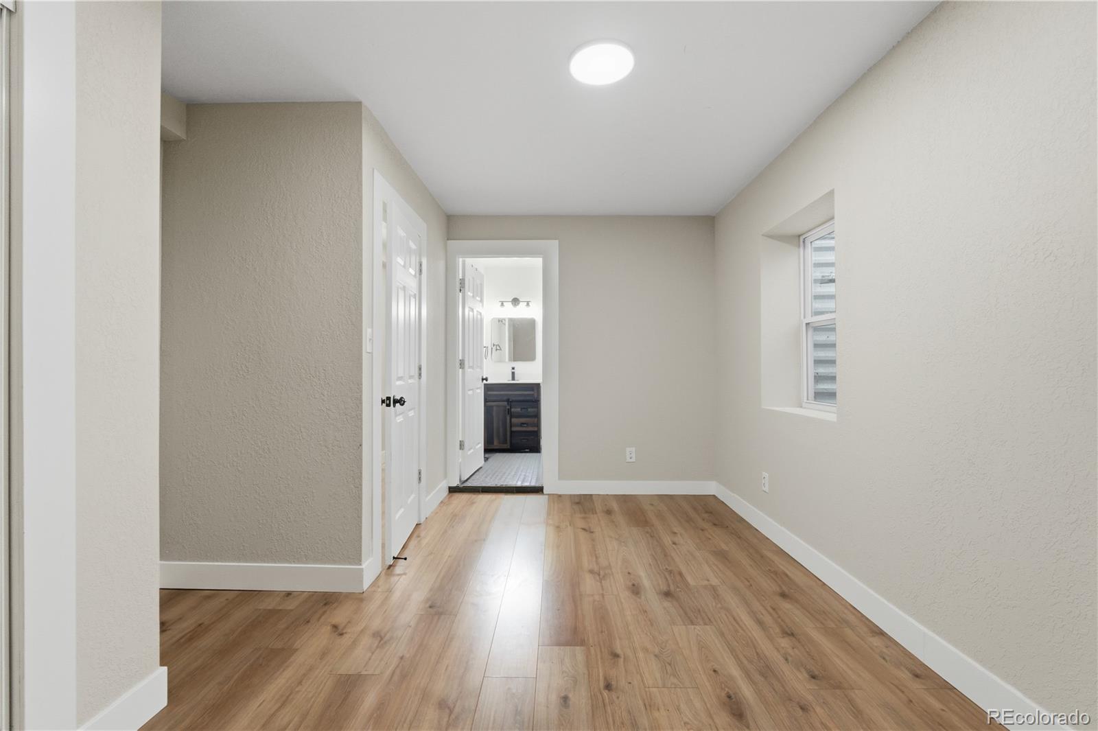 610 6th Street Bennett, CO 80102 - Photo 31 of 34 wooden floor in an empty room with a window