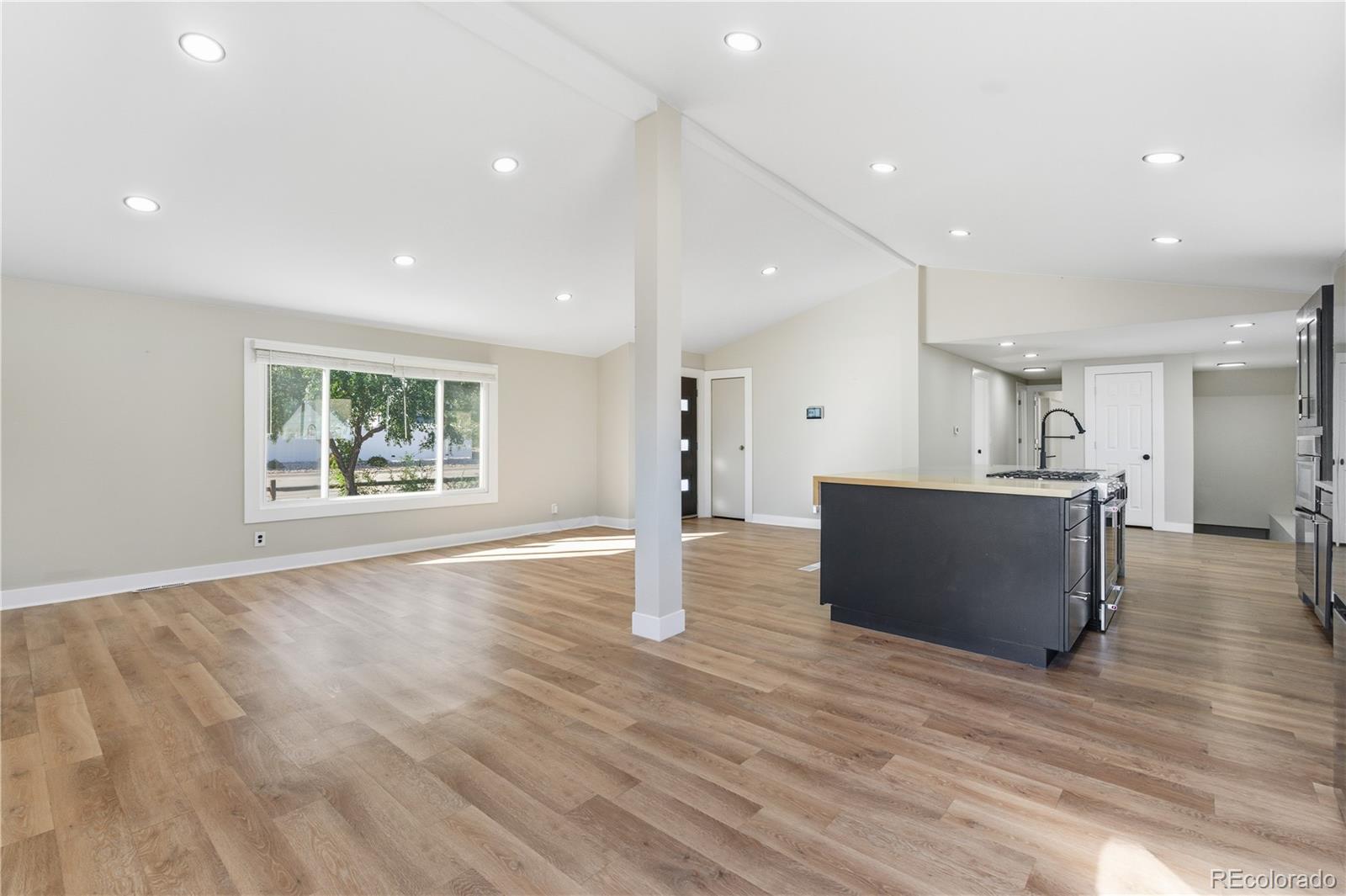 610 6th Street Bennett, CO 80102 - Photo 8 of 34 a open kitchen with stainless steel appliances granite countertop a refrigerator and a stove top oven