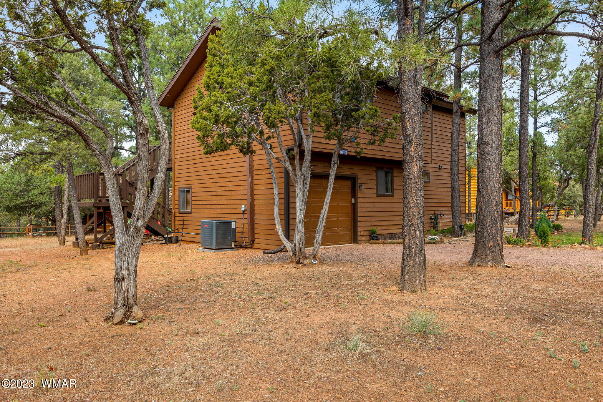 2276 Lindberg Road Overgaard, AZ 85933 - Photo 18 of 34 a house with trees in the background