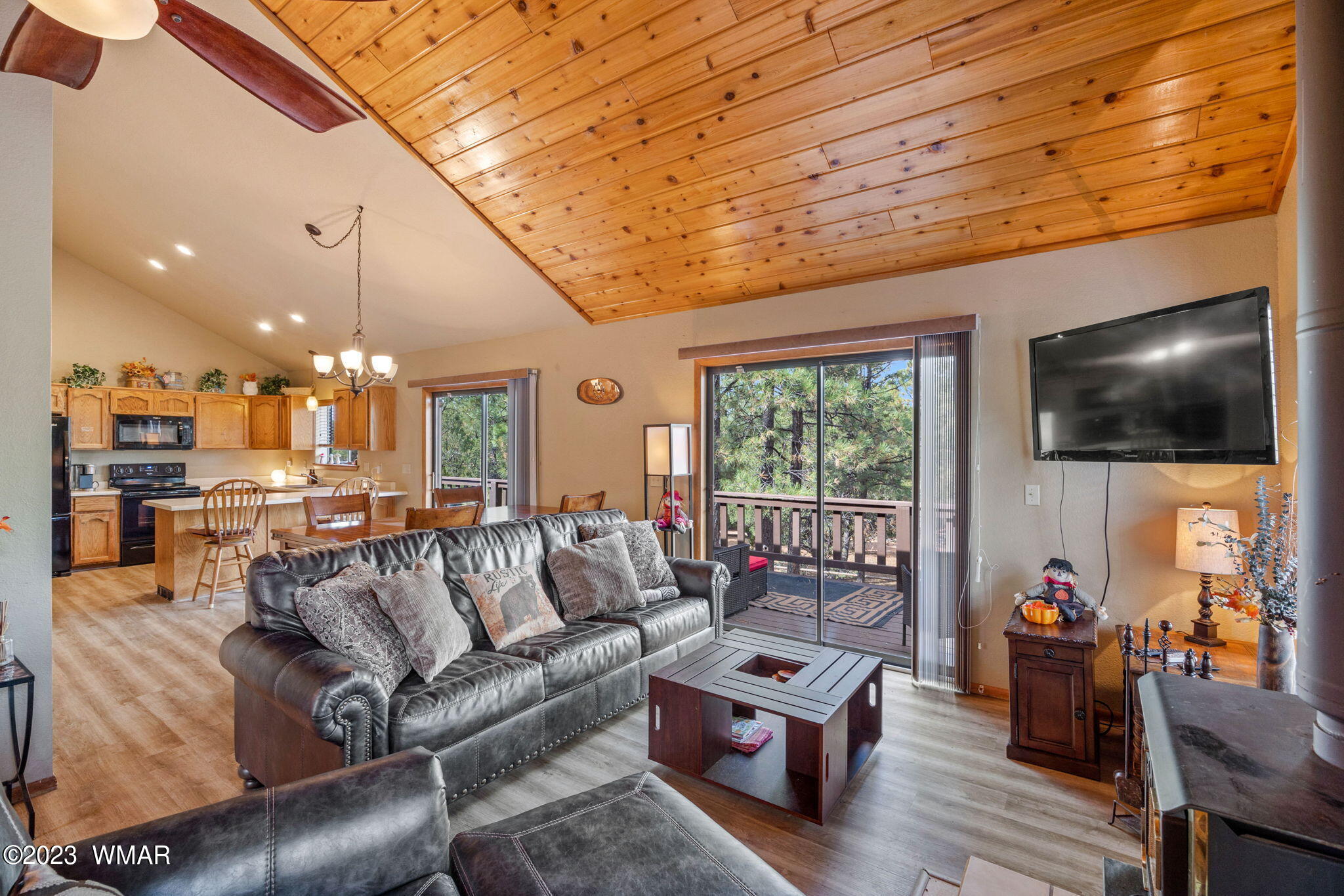 2276 Lindberg Road Overgaard, AZ 85933 - Photo 5 of 34 a living room with furniture a flat screen tv and kitchen view