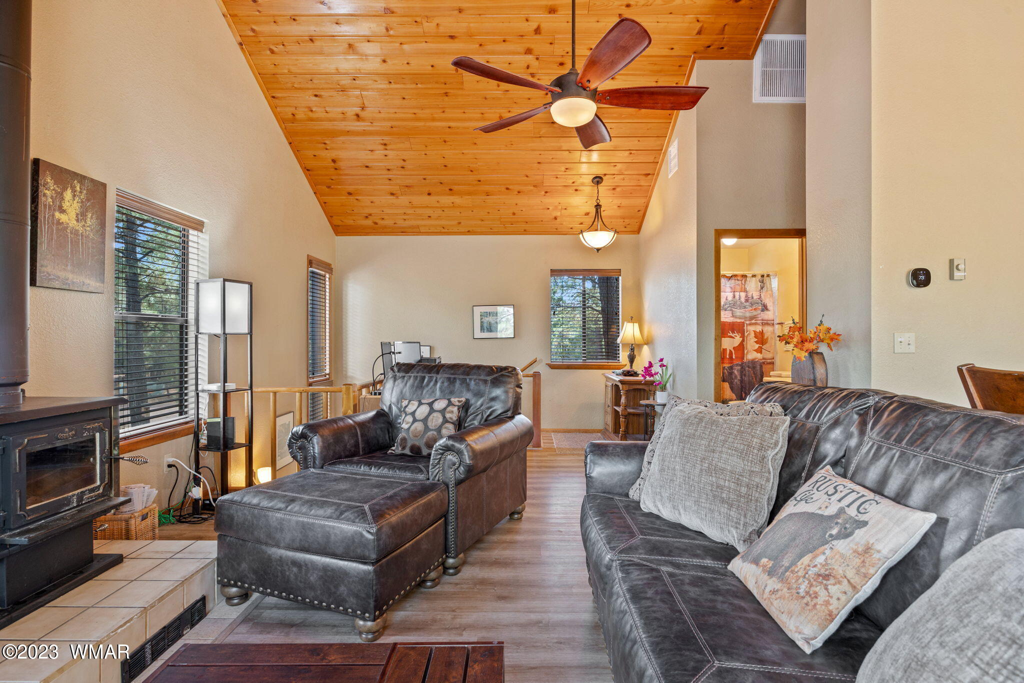 2276 Lindberg Road Overgaard, AZ 85933 - Photo 10 of 34 a living room with furniture a fireplace and a flat screen tv