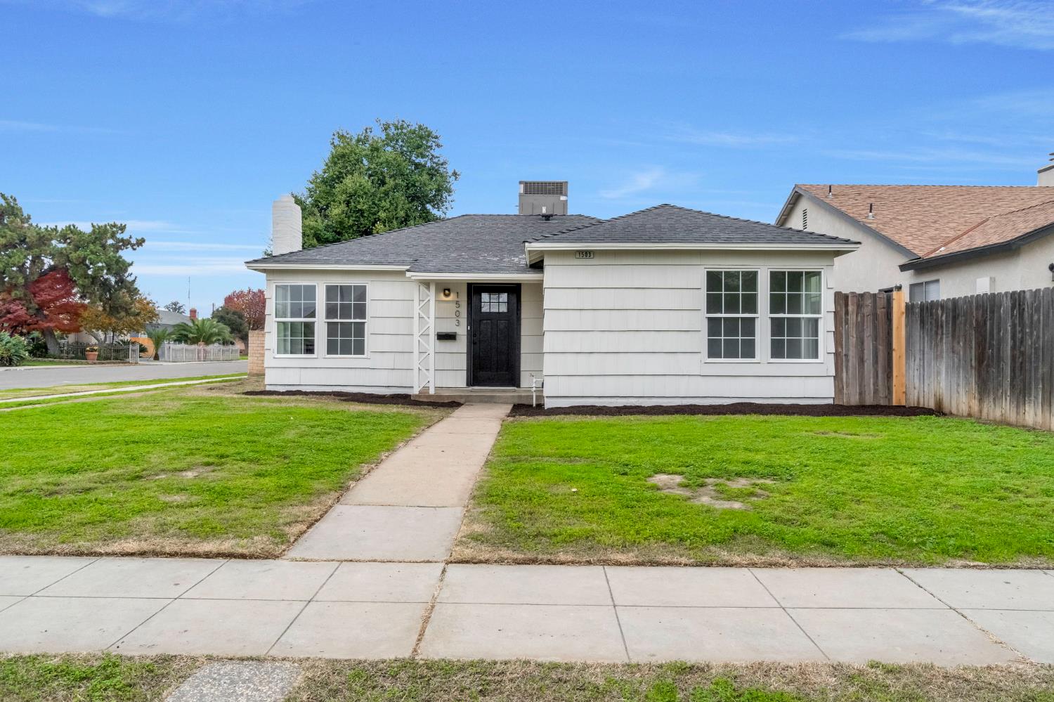 a front view of a house with a garden