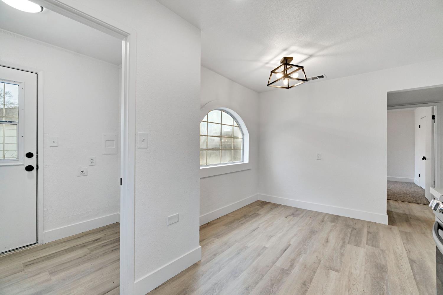 1503 North Pacific Avenue Fresno, CA 93728 - Photo 14 of 26 wooden floor in an empty room with a window