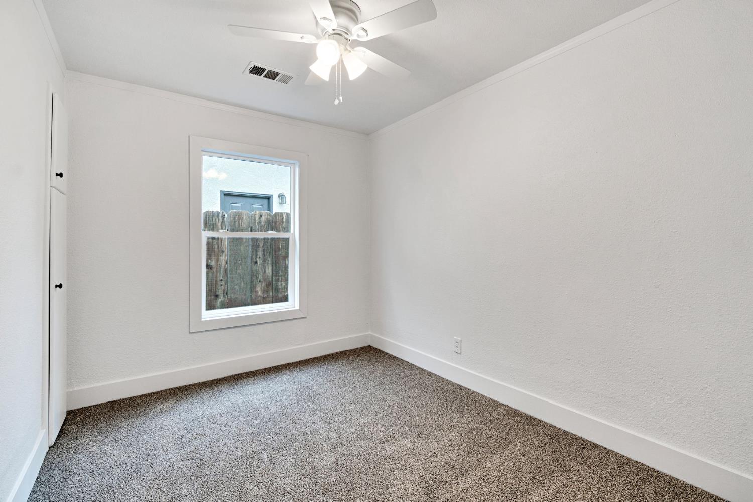 1503 North Pacific Avenue Fresno, CA 93728 - Photo 18 of 26 an empty room with a window and a fan