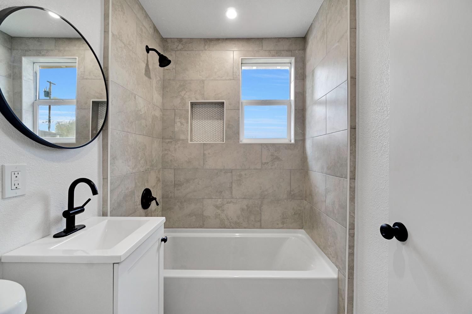 1503 North Pacific Avenue Fresno, CA 93728 - Photo 22 of 26 a bathroom with a sink a toilet and a mirror