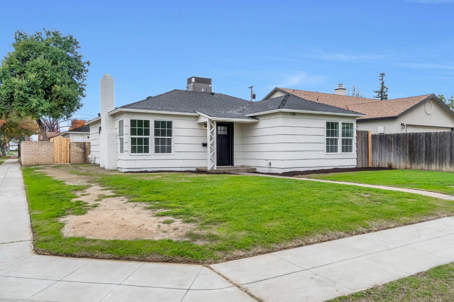 1503 North Pacific Avenue Fresno, CA 93728 - Photo 3 of 26 a front view of a house with a garden