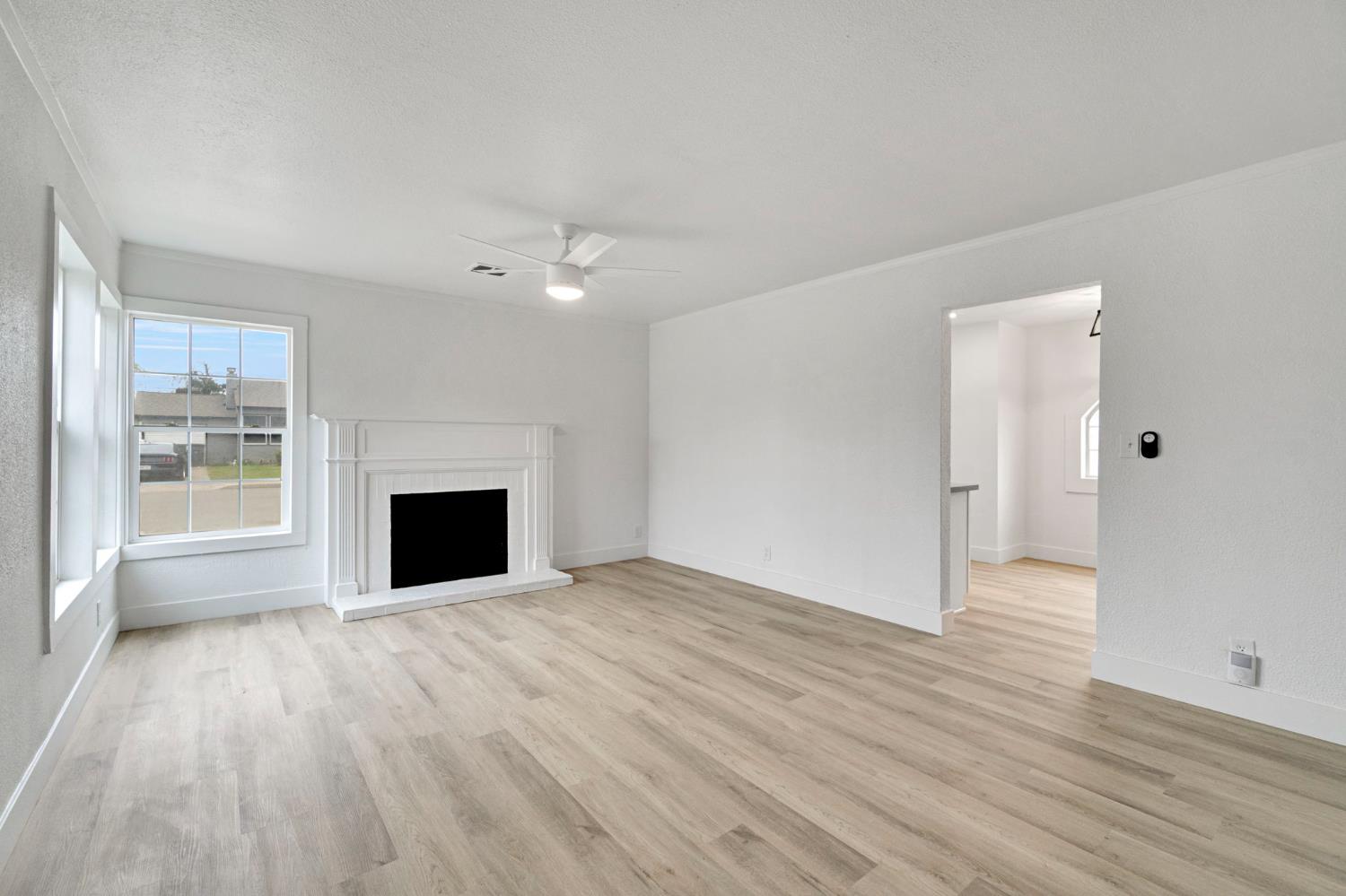 1503 North Pacific Avenue Fresno, CA 93728 - Photo 5 of 26 wooden floor in an empty room with a window