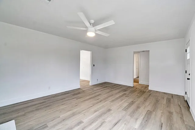 a view of an empty room and wooden floor
