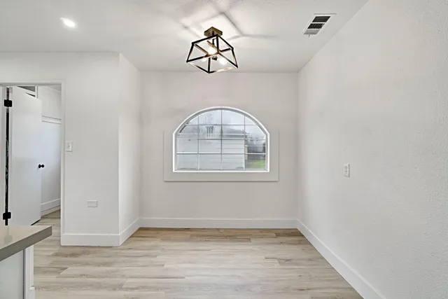 a view of an entryway with wooden floor