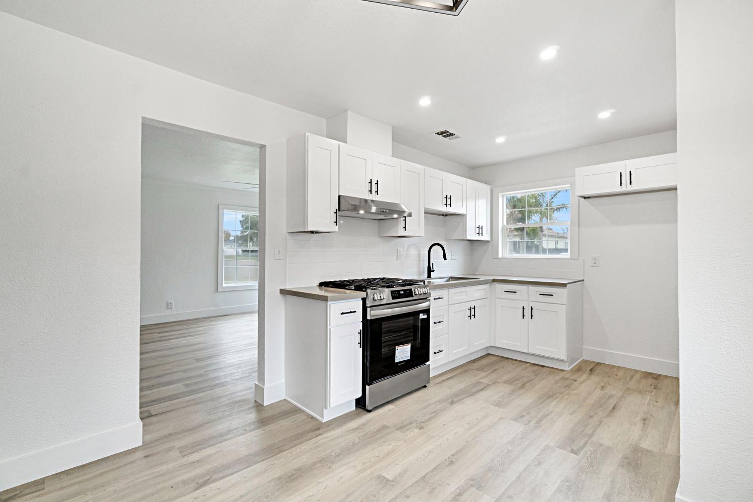 1503 North Pacific Avenue Fresno, CA 93728 - Photo 9 of 26 a kitchen with stainless steel appliances granite countertop a stove a sink and a refrigerator