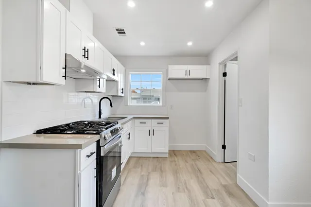 a kitchen with stainless steel appliances granite countertop a stove and a refrigerator