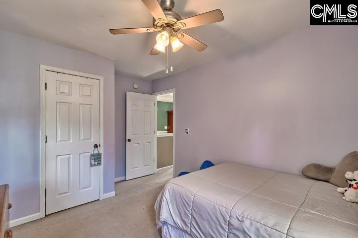 209 Eagle Pointe Drive Chapin, SC 29036 - Photo 27 of 40 a bedroom with a bed and a chandelier fan
