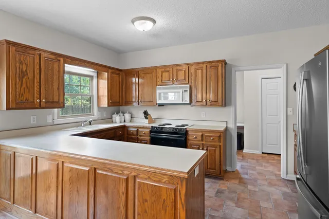 a kitchen with a sink stove and cabinets