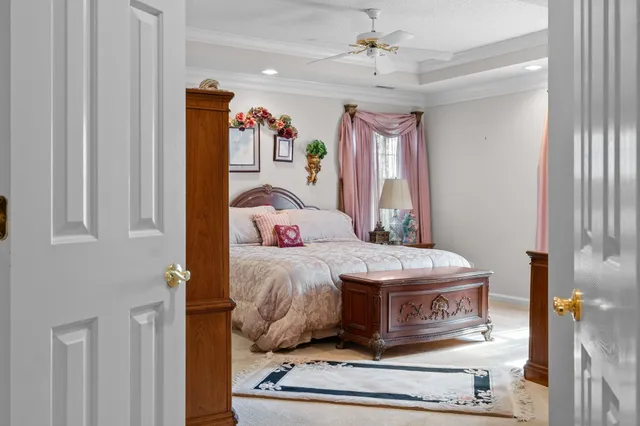 a bedroom with a large bed and a chandelier