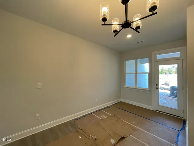 an empty room with a ceiling fan and window