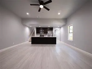 a view of a kitchen with a sink and a window