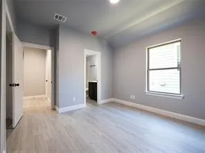 an empty room with windows and closet