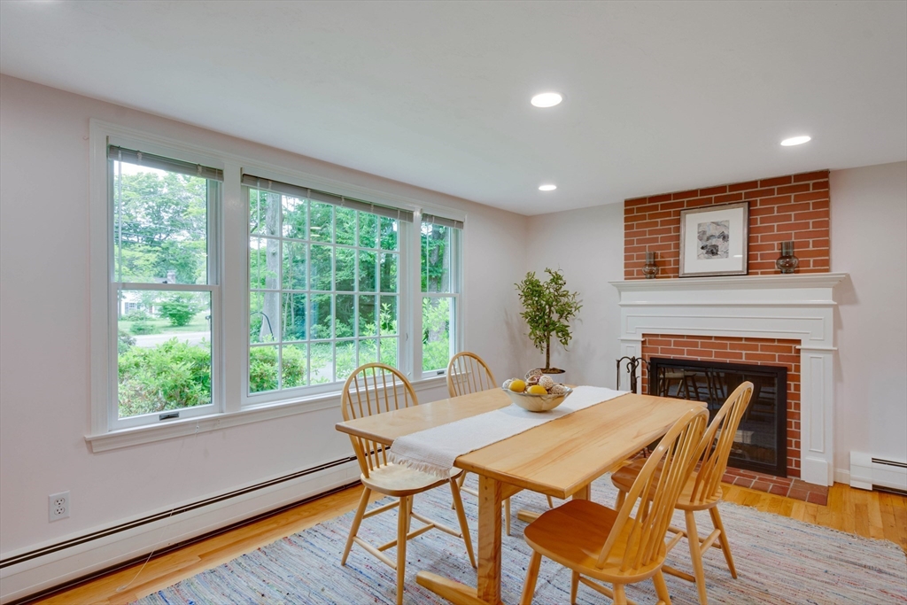 33 Farrar Road Lincoln, MA 01773 - Photo 5 of 31 a dining room with furniture a fireplace and wooden floor