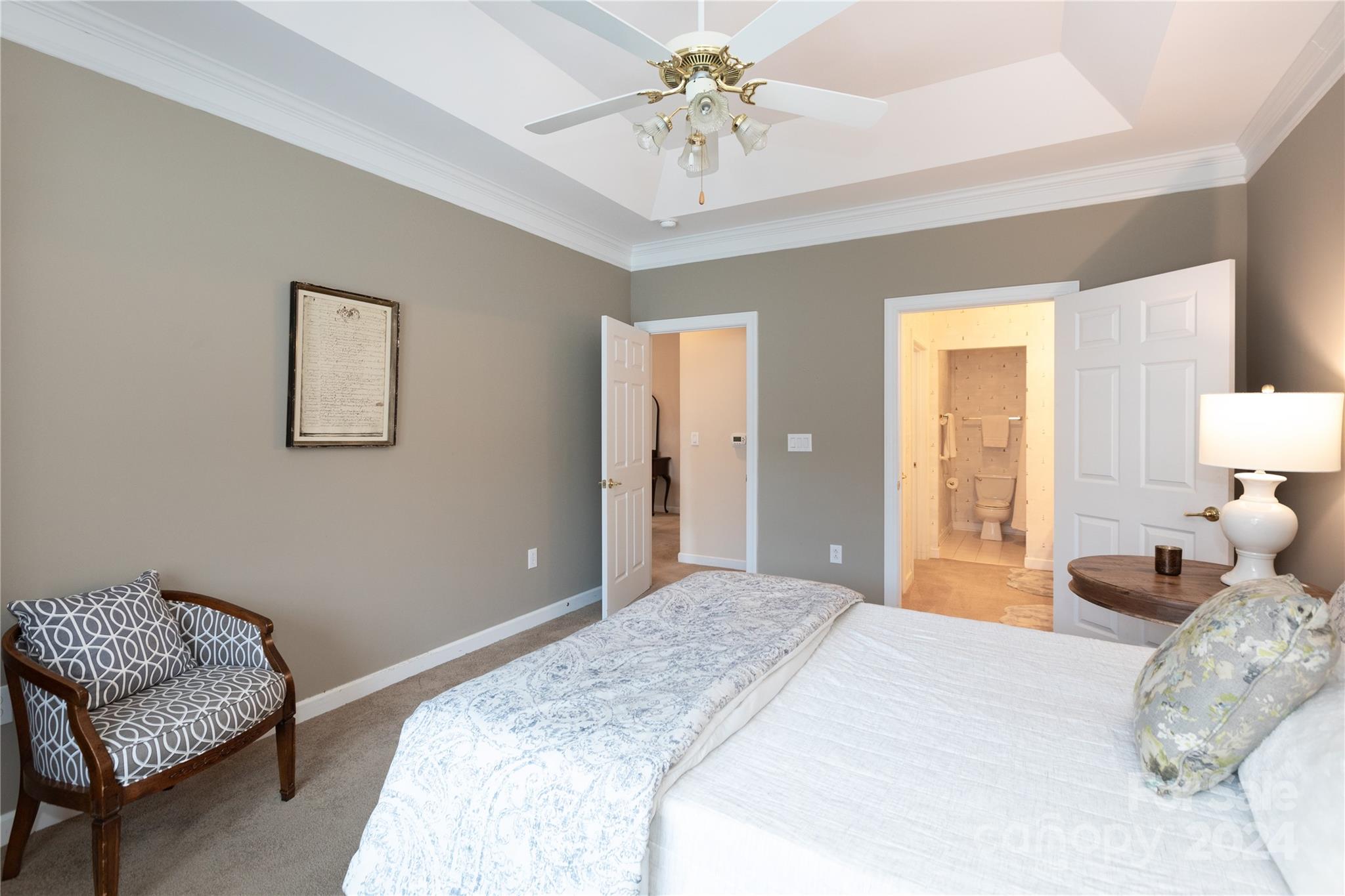 8368 Windsor Ridge Drive Charlotte, NC 28277 - Photo 16 of 28 a bedroom with a bed and a chandelier