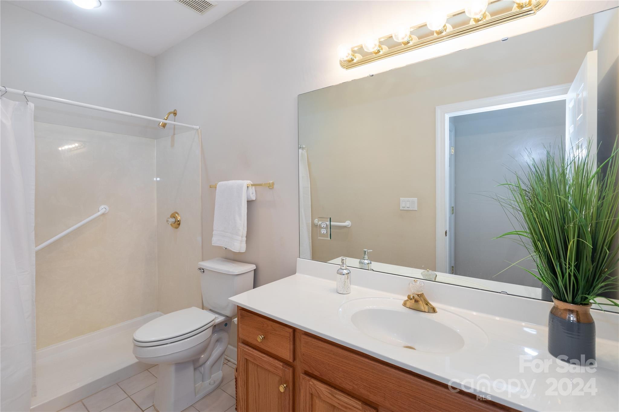 8368 Windsor Ridge Drive Charlotte, NC 28277 - Photo 23 of 28 a bathroom with a sink a toilet a mirror and shower
