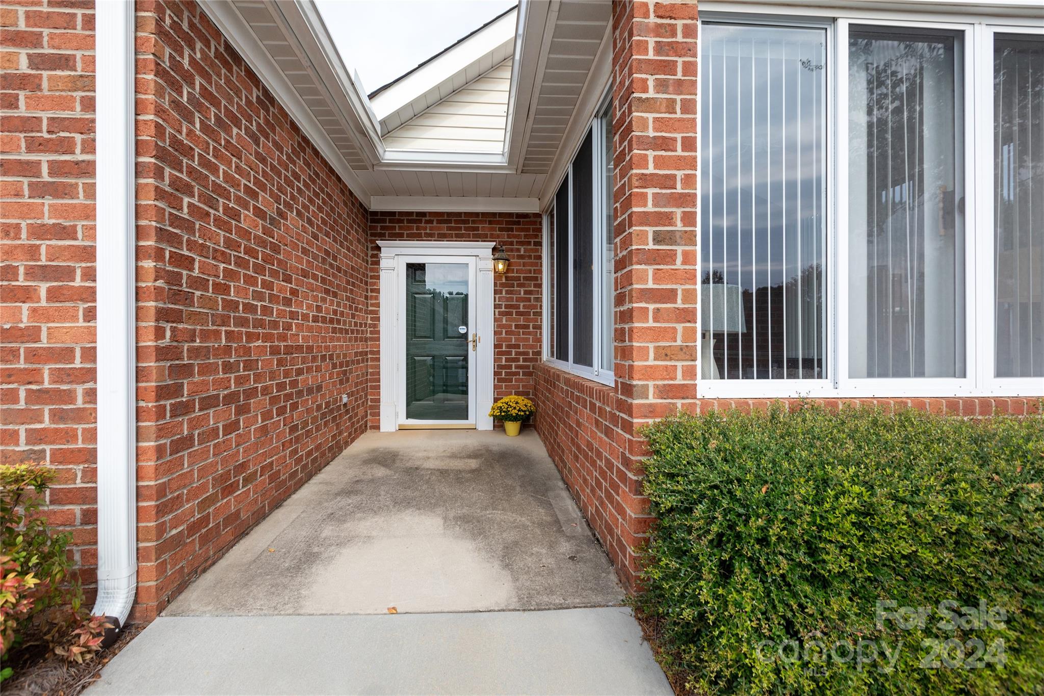 8368 Windsor Ridge Drive Charlotte, NC 28277 - Photo 24 of 28 a view of a brick house with large windows