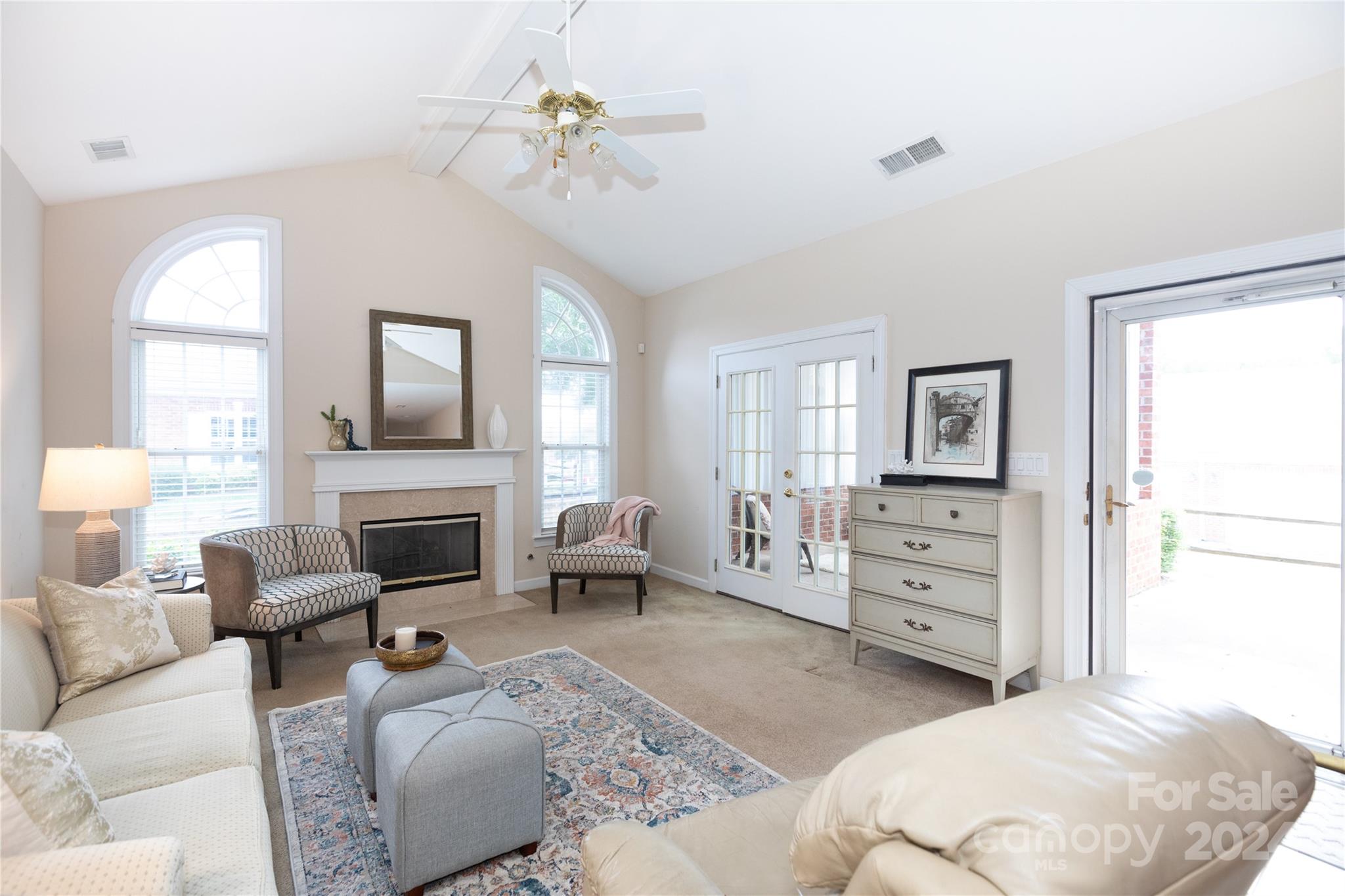 8368 Windsor Ridge Drive Charlotte, NC 28277 - Photo 3 of 28 a living room with furniture a fireplace and a chandelier