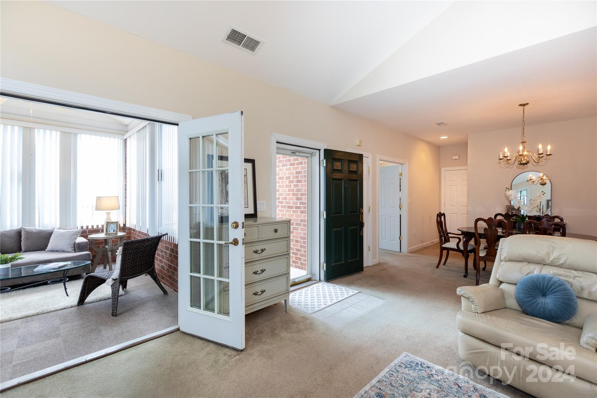 8368 Windsor Ridge Drive Charlotte, NC 28277 - Photo 6 of 28 a living room with furniture and a chandelier