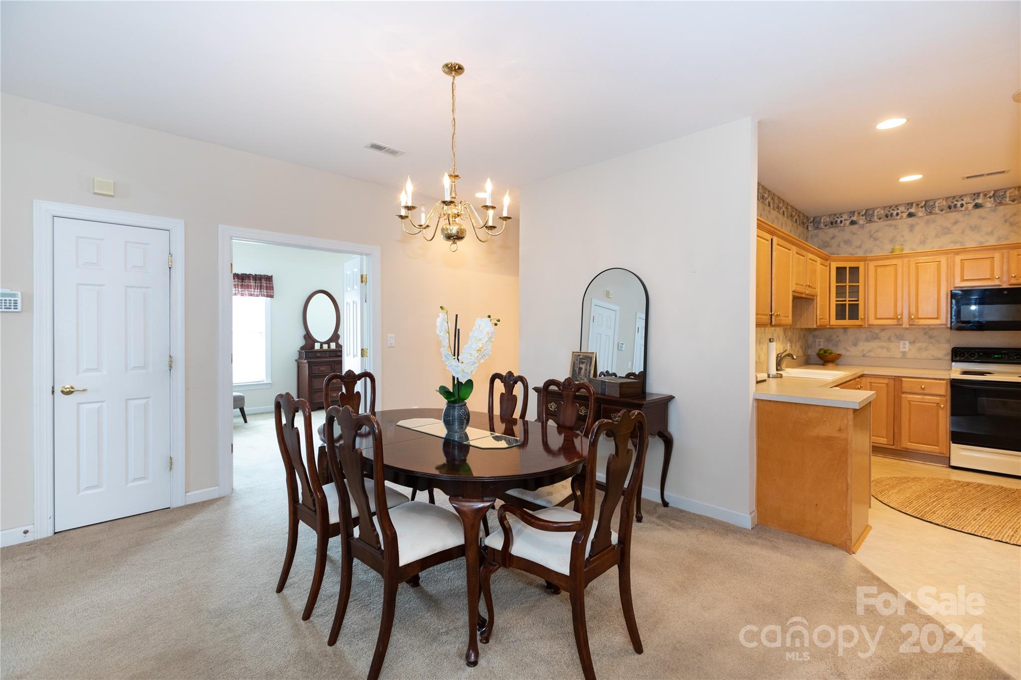 8368 Windsor Ridge Drive Charlotte, NC 28277 - Photo 8 of 28 a view of a dining room and kitchen with a table chairs