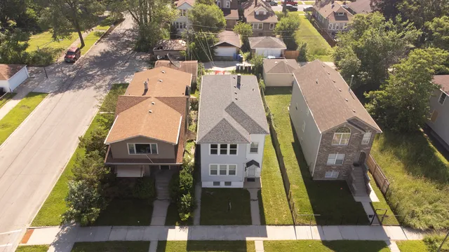 an aerial view of residential houses with outdoor space
