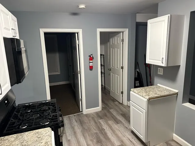 a kitchen with stainless steel appliances granite countertop a refrigerator and a stove