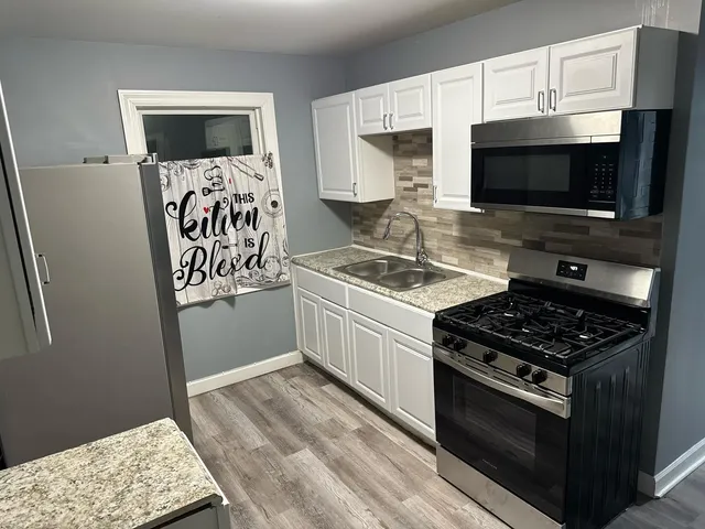 a kitchen with stainless steel appliances a stove a microwave and cabinets