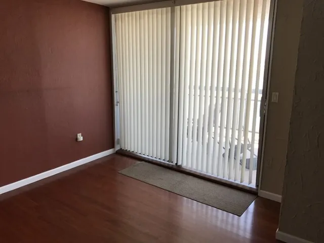 a kitchen with granite countertop a sink a stove and cabinets