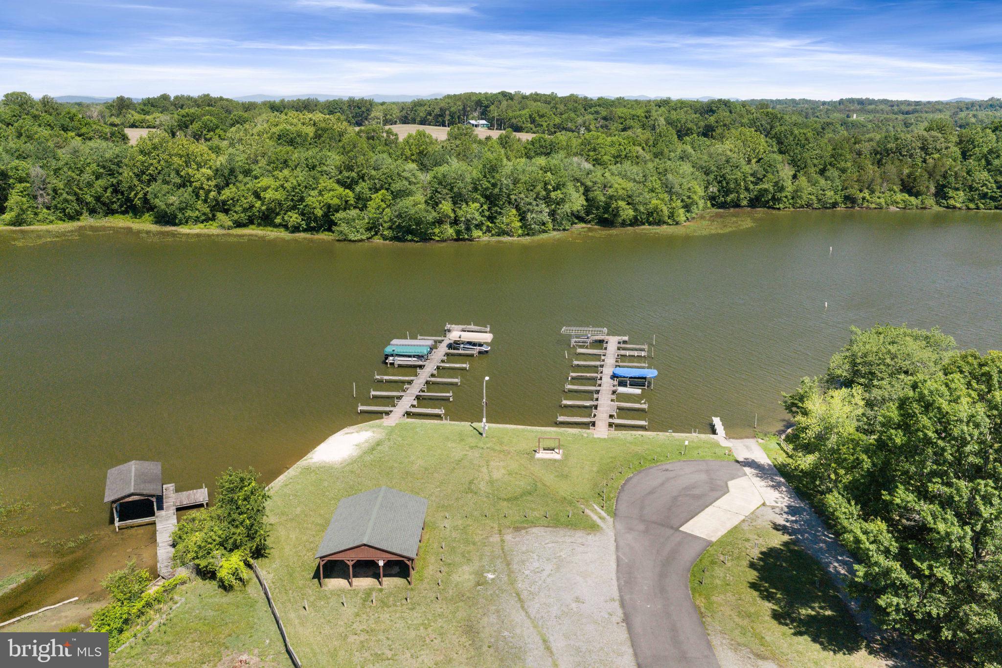 161 Troy Road Louisa, VA 23093 - Photo 56 of 60 an aerial view of a house with a yard and lake view