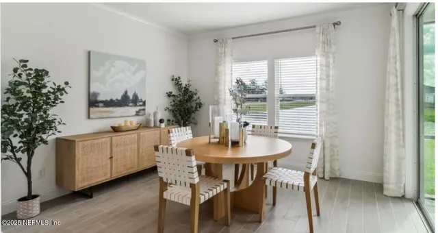 a dining room with furniture and wooden floor