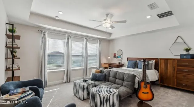 a kitchen with stainless steel appliances granite countertop a dining table chairs refrigerator and microwave