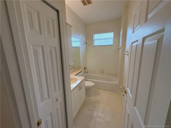 a bathroom with bathtub shower and toilet