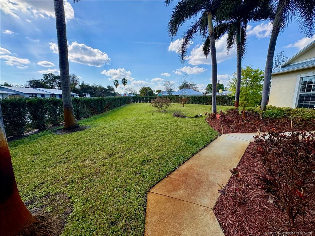 947 Northwest 13th Street Stuart, FL 34994 - Photo 17 of 23 a view of a garden with a building in the background
