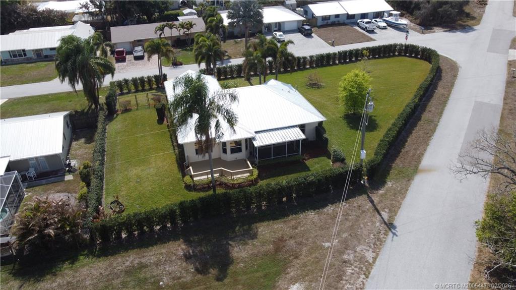 947 Northwest 13th Street Stuart, FL 34994 - Photo 2 of 23 an aerial view of a house with a swimming pool and outdoor seating