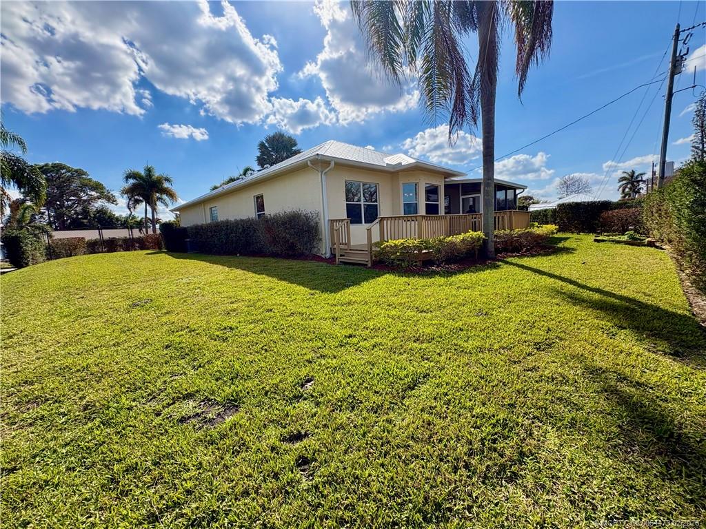 947 Northwest 13th Street Stuart, FL 34994 - Photo 21 of 23 a view of a house with a yard