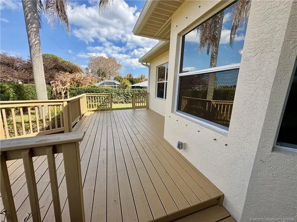 a view of a balcony with wooden floor
