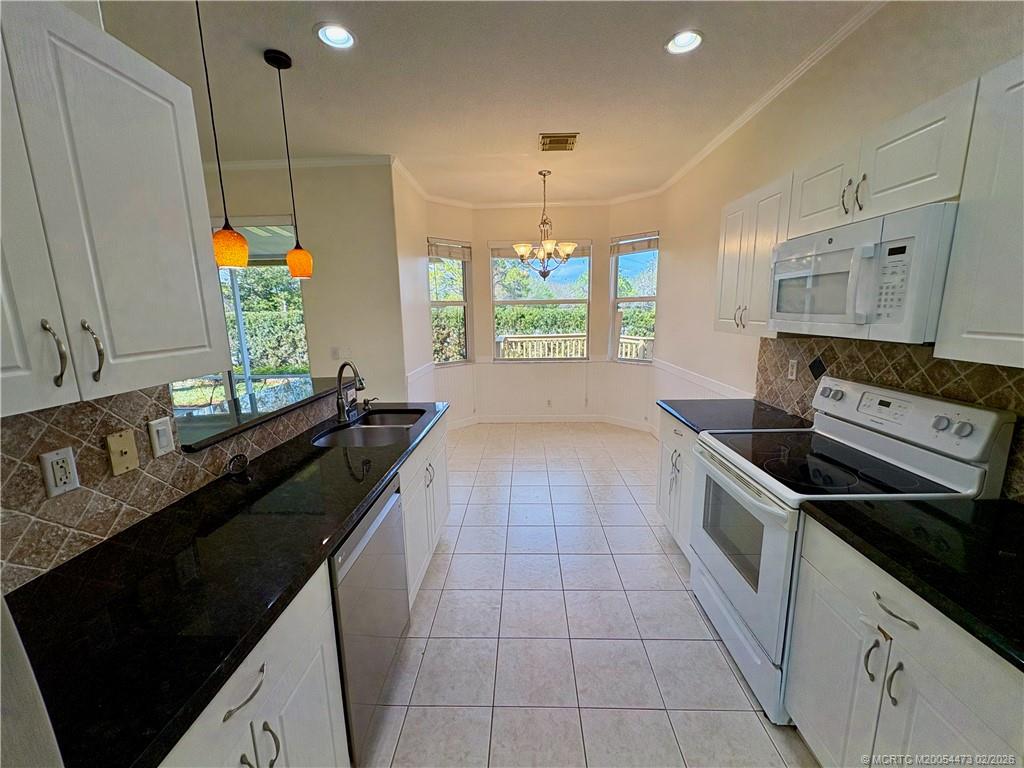 947 Northwest 13th Street Stuart, FL 34994 - Photo 7 of 23 a kitchen with a sink stove and cabinets
