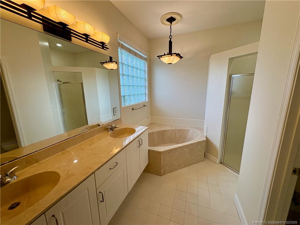 947 Northwest 13th Street Stuart, FL 34994 - Photo 10 of 23 a spacious bathroom with a tub sink and mirror