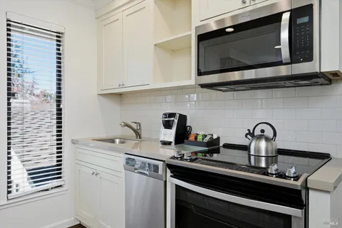 a kitchen with a sink stove and microwave