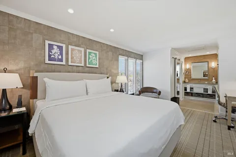 a bed room with a bed and a large mirror